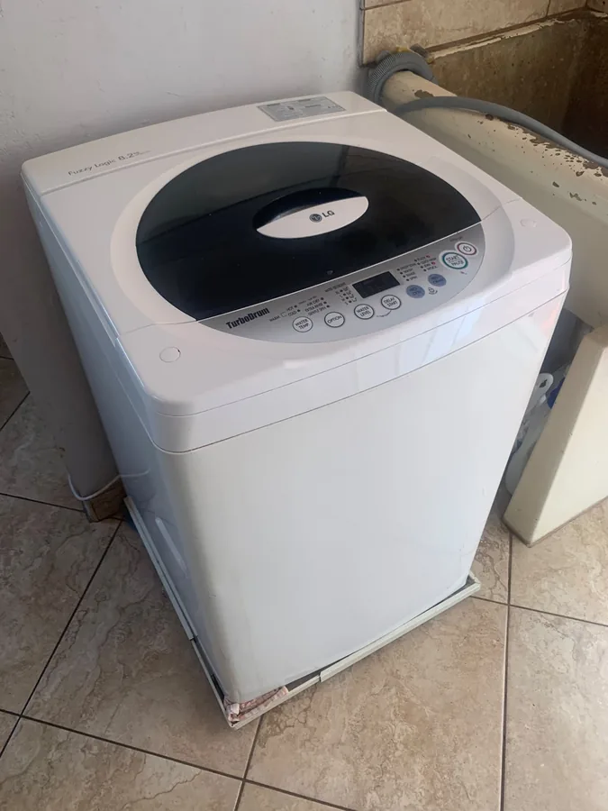 Technician providing washing machine repair service in Durban North